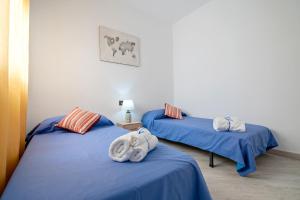 two beds in a room with towels on them at Cambrils Turistic 3a in Cambrils +17 photos