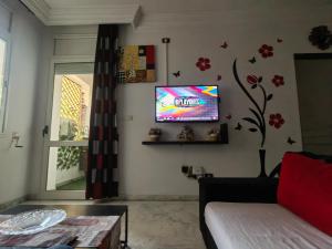 a living room with a tv on the wall at self checkin in Tunis +6 photos