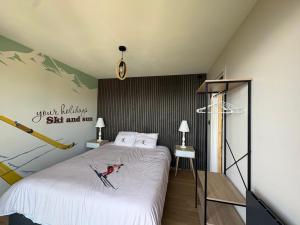 a bedroom with a bed with a dog on it at Flocons 48 in Villarembert