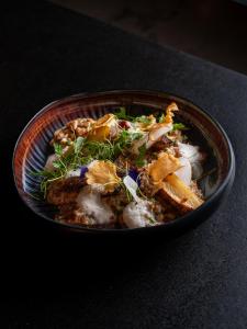 a bowl of food sitting on a table at Hôtel Spa Restaurant Villa Castellane by Germain Collection in Gréoux-les-Bains
