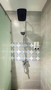 a shower stall in a bathroom with a shower at Seaforest Hotel by Haviland in Danang