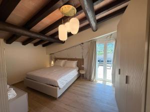 a bedroom with a bed and a ceiling with beams at Hotel Borgo Albador in Posada