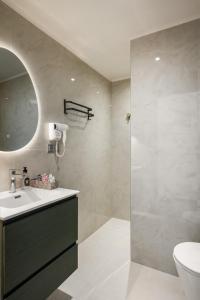 a bathroom with a sink and a toilet and a mirror at MustBe CFU Studios in Danilia +28 photos