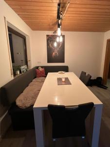 a living room with a table and a couch at Tannennest in Seewald