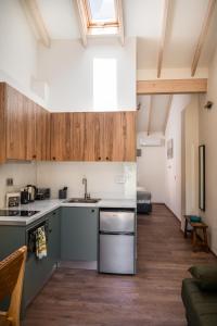 a kitchen with a sink and a stove top oven at MustBe CFU Studios in Danilia