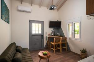 a living room with a couch and a table at MustBe CFU Studios in Danilia