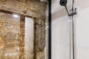 a shower with a glass door in a bathroom at Casa do Moinho in Aboim +23 photos