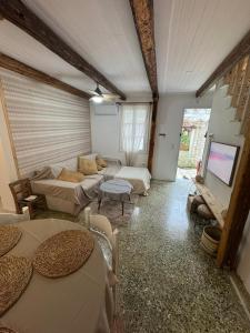 a living room with couches and a flat screen tv at Blau Haus Townhouse in Lefkada