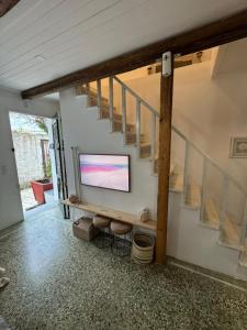 a living room with a flat screen tv on a wall at Blau Haus Townhouse in Lefkada