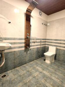 a bathroom with a toilet and a sink at Newly Launched Servostay Luxe Botique Hotel Near Miyapur Metro in Lingampalli