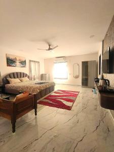 a living room with a bed and a rug at Newly Launched Servostay Luxe Botique Hotel Near Miyapur Metro in Lingampalli +10 photos