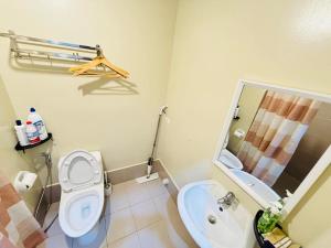 a bathroom with a toilet and a sink at Jaystaycation in Iloilo City