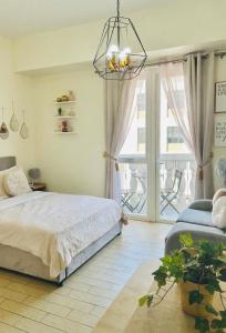 a bedroom with a bed and a large window at Jaystaycation in Iloilo City