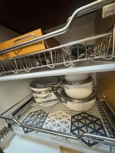 a shelf in a refrigerator filled with dishes at D Grey Pillows - 16th Floor One-Bedroom Condo Unit with Sea View in Pontud