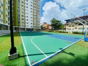 an empty tennis court in front of a building at D Grey Pillows - 16th Floor One-Bedroom Condo Unit with Sea View in Pontud