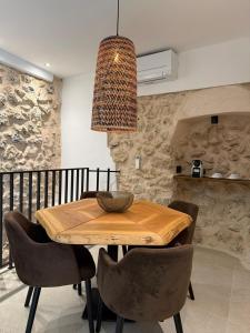 a dining room with a wooden table and chairs at Casa Tramuntana in El Port de la Selva