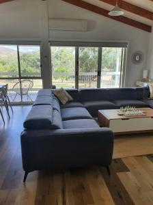 a living room with a blue couch and a table at Mudita at Bonnie Doon in Bonnie Doon
