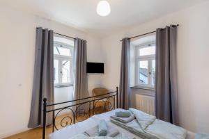 a bedroom with a bed and two windows at Eifel with Family in Thür