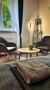 a living room with two chairs and a coffee table at podZZamkem in Jaroslavice +28 photos