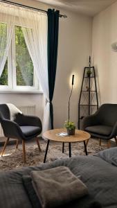a living room with two chairs and a coffee table at podZZamkem in Jaroslavice