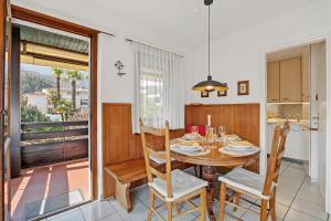 a kitchen and dining room with a table and chairs at Casa Viola Losone for 8 - Happy Rentals in Losone