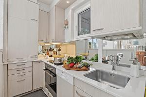 a kitchen with white cabinets and a sink at Casa Viola Losone for 8 - Happy Rentals in Losone
