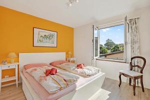 a bedroom with a bed and a window at Casa Viola Losone for 8 - Happy Rentals in Losone +36 photos