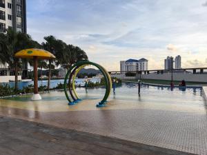 a roller coaster in the middle of a pool at Metropol Summer Cozy Suite in Bukit Mertajam