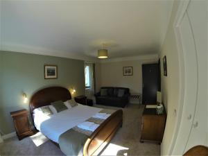 a bedroom with a large bed and a couch at Auberge de la Sagne in Cabrerets +19 photos