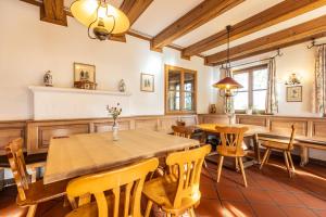 a dining room with wooden tables and chairs at Hotel Holledau in Geisenhausen