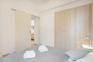 a bedroom with a bed with towels on it at Nikos House in Ierapetra