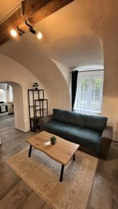 a living room with a couch and a coffee table at podZZamkem in Jaroslavice