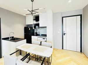 a kitchen and dining room with a table and chairs at Legendary 2 Bdr Comfort in Bang Tao Beach