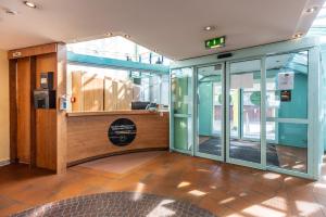 an entrance to a building with a revolving door at Hotel Holledau in Geisenhausen