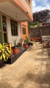 a porch of a house with potted plants on it at Malaika Villas in Kampala