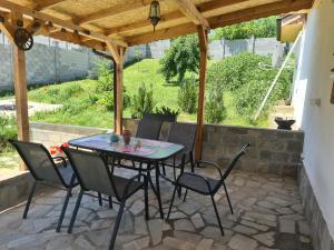 a patio with a table and chairs under a pergola at Haus Kazimir in Kazimir