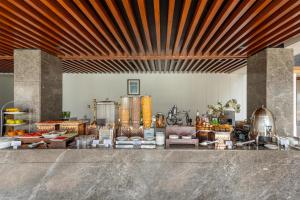 a lobby with a counter with food on it at Radisson Hotel Sonamarg in Sonāmarg