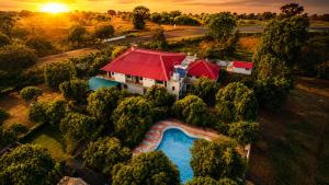 an aerial view of a house with a swimming pool at Vanveli The Forest Resort in Sasan Gir