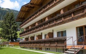 a building with wooden balconies on the side of it at first mountain Hotel Zillertal in Aschau