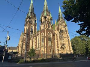 an old church with two towers on a street at Historical Apartments by Stepan Fedak in Lviv
