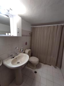 a bathroom with a sink and a toilet at Mare Blu Sole in Karpathos