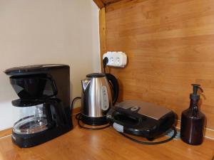 a coffeemaker and coffee maker sitting on a counter at Terme Olimia - Apartment Lipa 112 in Podčetrtek