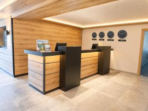 a room with a counter with plates on the wall at first mountain Hotel Zillertal in Aschau