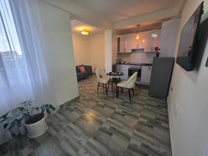 a kitchen and living room with a table and chairs at Goldsip lounge in Dirē Kʼalu