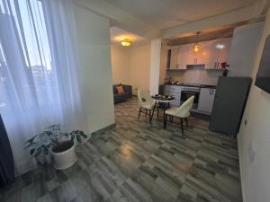 a kitchen and a living room with a table and chairs at Goldsip lounge in Dirē Kʼalu +5 photos