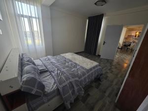 a bedroom with a bed and a desk in it at Goldsip lounge in Dirē Kʼalu
