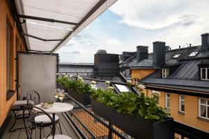 a balcony with a table and some plants on it at Villa Dagmar in Stockholm