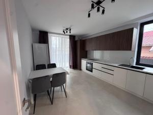 a kitchen with a table and chairs in a room at Apart Hotel Balti 2 in Bălţi