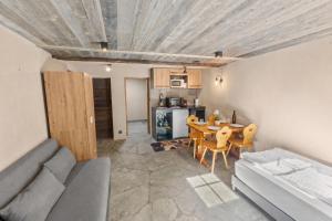 a living room with a couch and a table at Studio chaleureux au coeur d'un chalet alpin in Zinal