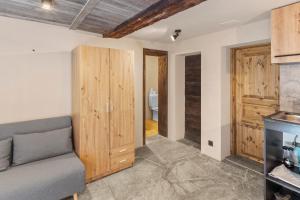 a living room with a couch and wooden walls at Studio chaleureux au coeur d'un chalet alpin in Zinal